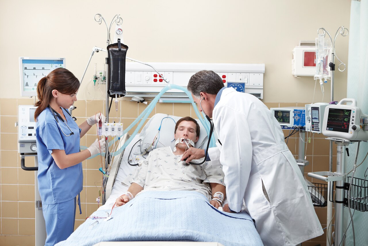 Patient connected to life support devices