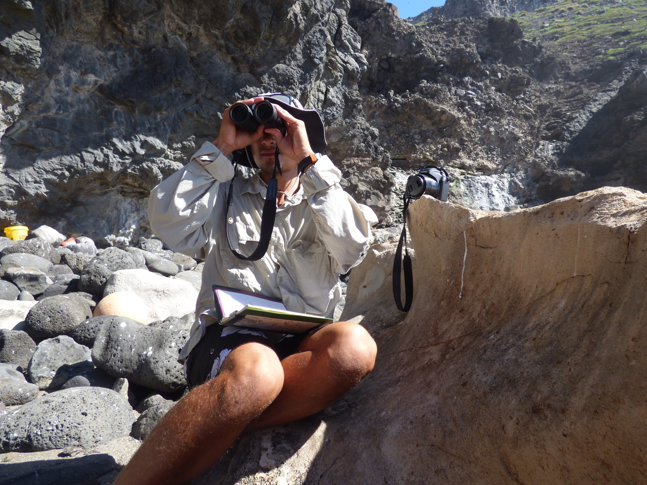 Field Researcher Keelan Barcina searches for monk seals along the shores of Nihoa Island.