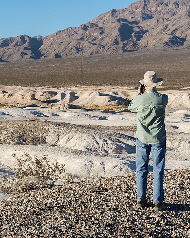 A photographer working in the desert landscape
