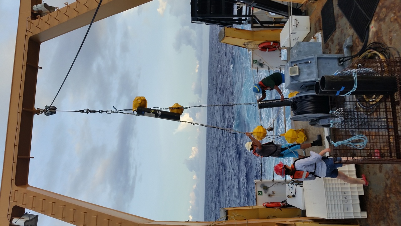 Scientists lower a recording package over the side of the ship