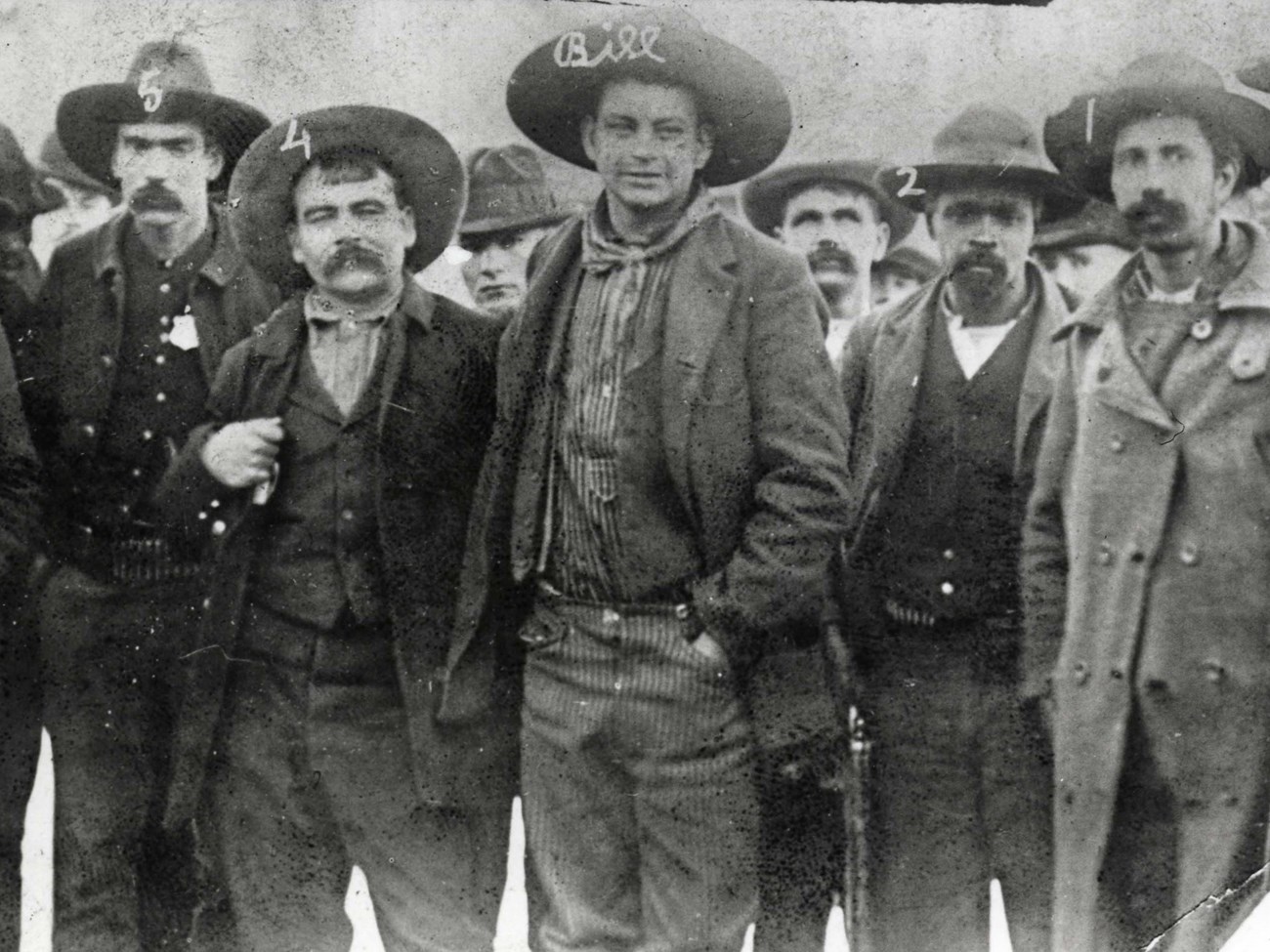 Black and white historic image of Cherokee Bill standing with deputy marshals that arrested him.