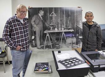 Volunteers Ben Gaddis (left) and Andrew Hara (right) holding a phot...