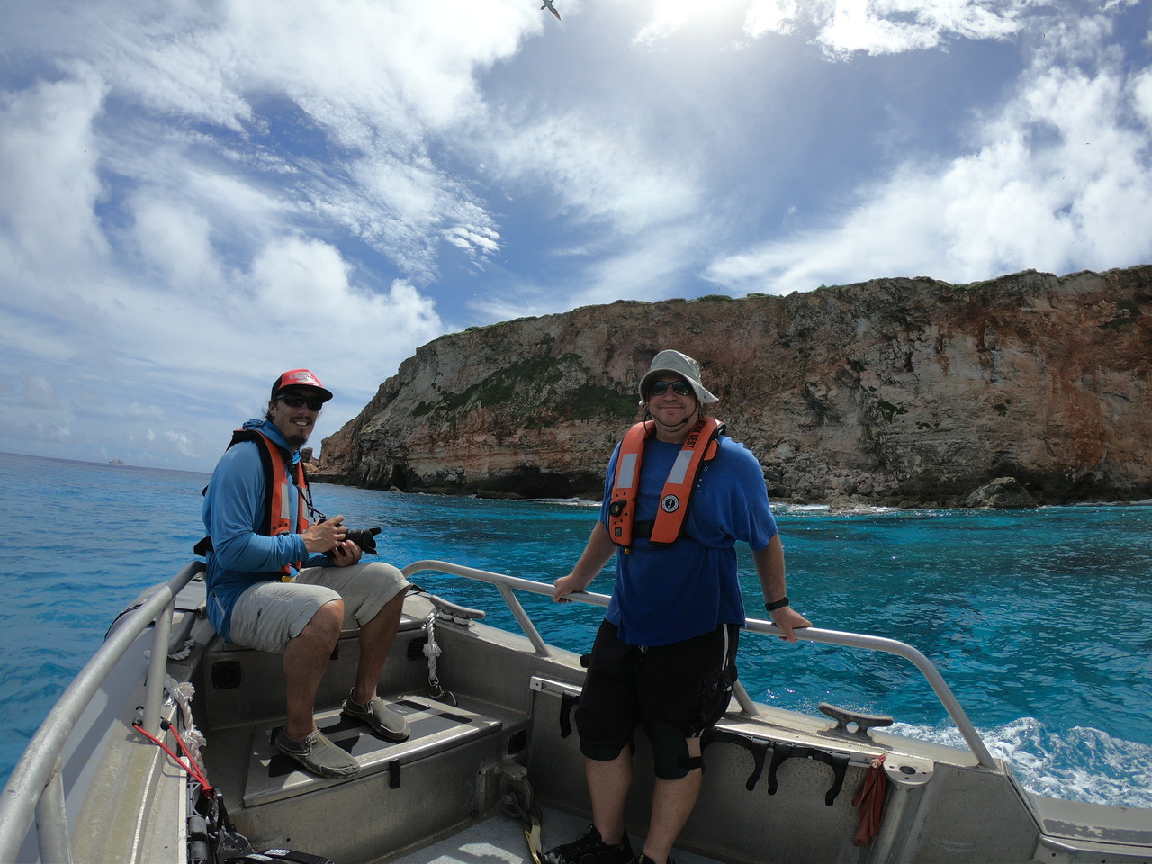 Observers in a small boat near the island
