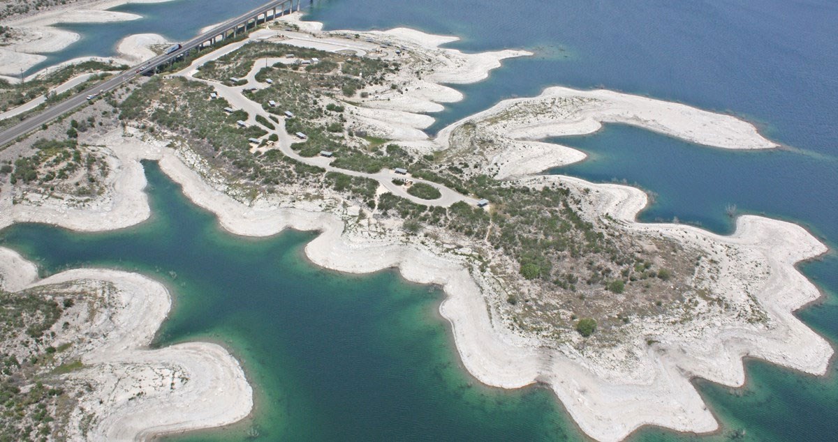 Aerial view of an exposed lakeshore at low water.