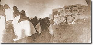 Army guards and Hopi prisoners with crowd waiting and watching at Hopi pueblo.