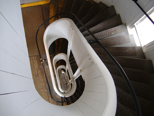 A spiral staircase inside a brick mill tower.