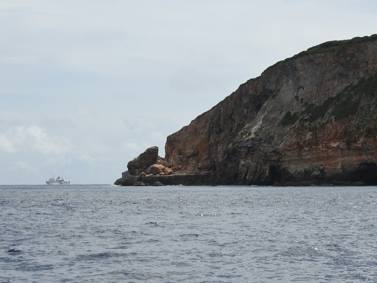 The NOAA Ship Oscar Elton Sette offshore of a small island