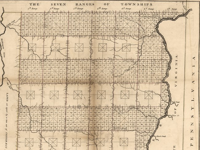 A black-and-white map of the Ohio River with the land beside it divided into numbered square parcels.