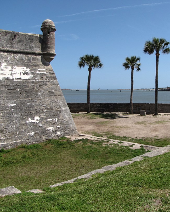 A fortress wall with the bay beyond.