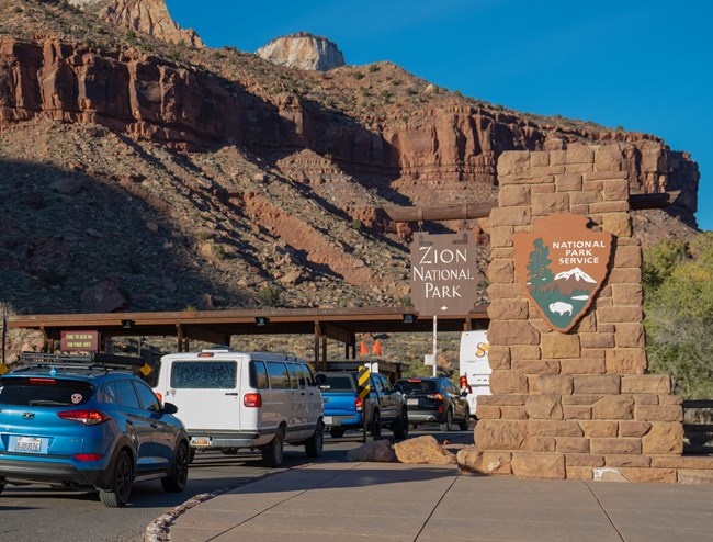Cars lined up at the Zion National Park entrance station.