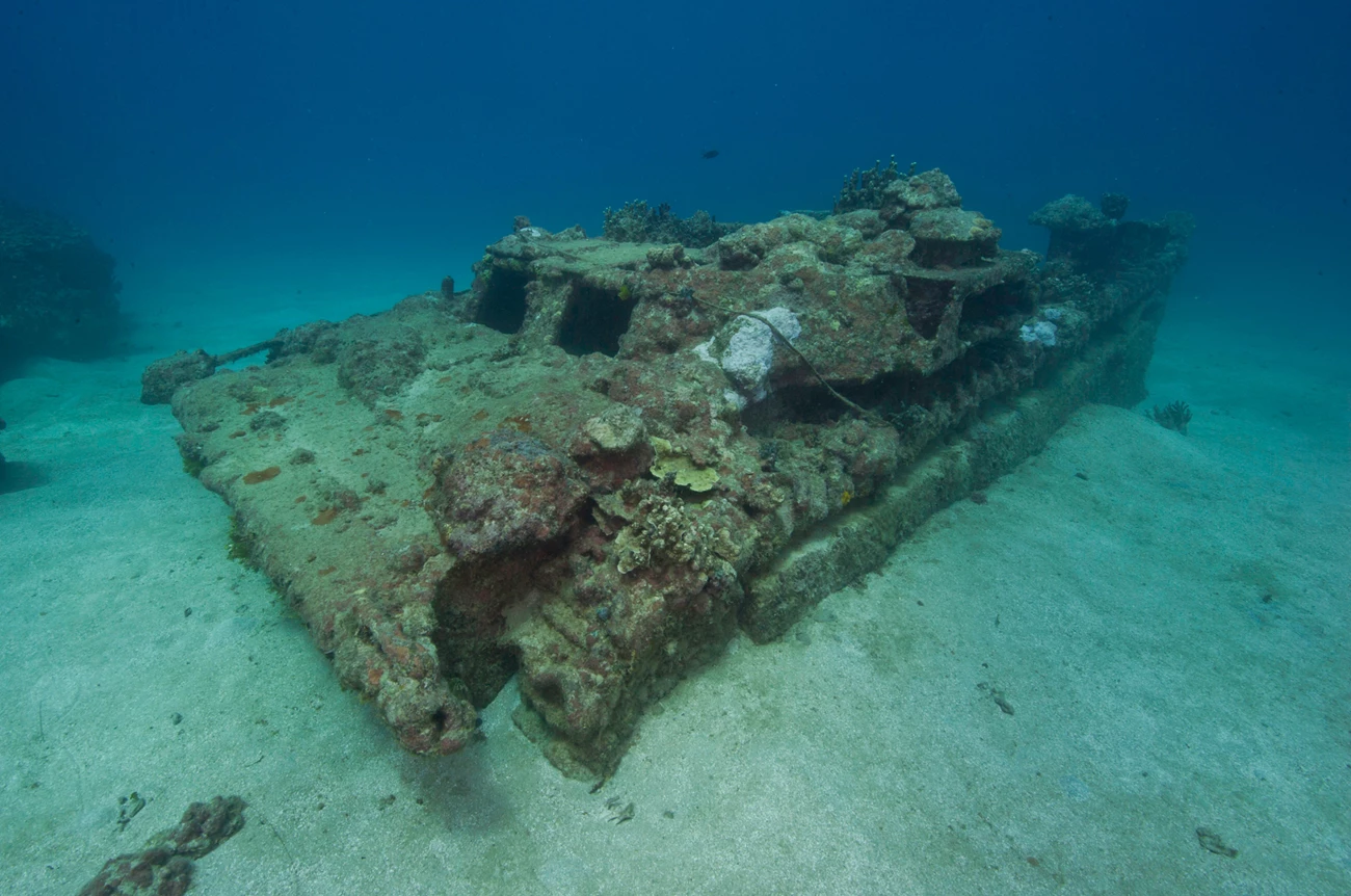 An amphibious tractor lying on the seafloor.