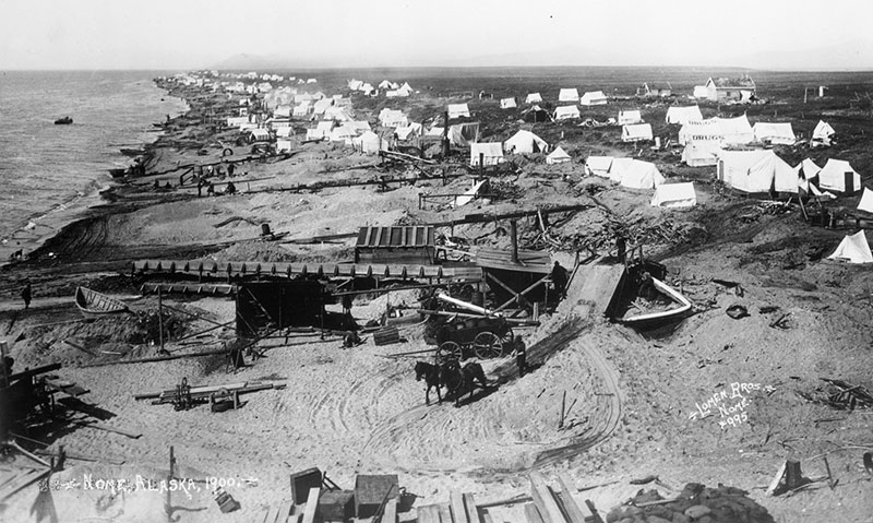 Tents and mining equipment on a beach at Nome in 1900