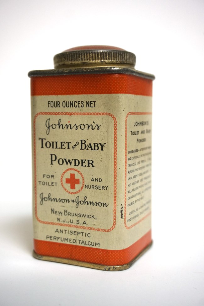 An old tin of baby powder with a red and white label.