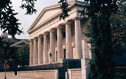 A Greek Revival building with eight marble columns.