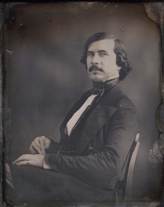A black-and-white portrait photograph of George Healy