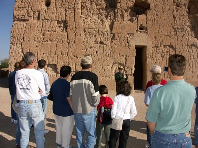 Visitors on a ranger-guided tour at the Great House ruins.