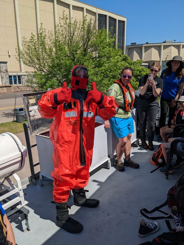 Great Lakes Aquarium Staffer tries on a gumby suit.